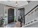 Bright foyer features a decorative pendant light, hardwood floors, and a staircase with white risers and dark handrail at 105 Carter Dr, Goose Creek, SC 29445
