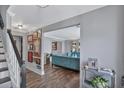 Open-concept living room with wood floors, gray walls, white trim and an aqua sofa at 105 Carter Dr, Goose Creek, SC 29445