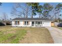 Attractive one-story house with a classic design, neat landscaping, and a driveway for convenient parking at 105 Gippy Dr, Summerville, SC 29486