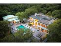 Aerial view of a home's outdoor pool and a covered outdoor lounge area surrounded by lush trees at 1105 Fort Lamar Rd, James Island, SC 29412