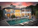 A backyard featuring a pool and a deck with outdoor seating, perfect for entertaining and relaxing at 1105 Fort Lamar Rd, James Island, SC 29412