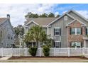 Beautiful home featuring a white picket fence, a well-maintained lawn, and a charming, inviting facade at 1588 Grey Marsh Rd, Mount Pleasant, SC 29466