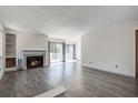 Open living room featuring a fireplace, balcony access, and modern flooring at 1714 Greystone Blvd # 47, Mount Pleasant, SC 29464