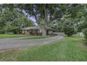 Brick home featuring mature trees, long driveway and covered carport at 1758 Mendel Rivers Rd, Saint Stephen, SC 29479