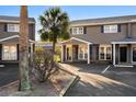 Attractive townhouse with a welcoming entrance, black shutters, and neatly arranged parking area at 1860 Mepkin Rd # H1, Charleston, SC 29407