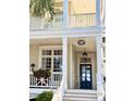 Inviting entrance with a charming sign, glass-paneled door, and decorative flower boxes at 2863 Jasper Blvd, Sullivans Island, SC 29482