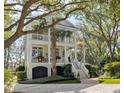 Stunning two-story home with a garage, inviting stairways, balconies, and landscaped surroundings at 2863 Jasper Blvd, Sullivans Island, SC 29482