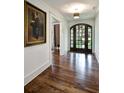 Elegant entryway with hardwood floors, arched doorway, and designer light fixture at 299 Hobcaw Dr, Mount Pleasant, SC 29464