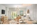 Open living space with dining table, patio doors, and stylish decor with modern lighting at 321 Pine Crest View Dr, Summerville, SC 29486