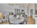 Bright kitchen with white cabinets, stainless steel appliances, and a dining area, and tile backsplash at 334 Pine Crest View Dr, Summerville, SC 29486