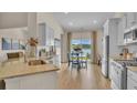 Open kitchen with granite countertops, stainless steel appliances, and a breakfast nook with lake views at 334 Pine Crest View Dr, Summerville, SC 29486