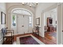 Grand foyer with arched doorway, chandelier, and hardwood floors, creating a welcoming entrance to the home at 38 State St # 2, Charleston, SC 29401