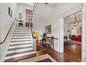 Elegant staircase with wooden steps and white risers, complemented by hardwood floors and natural light at 38 State St # 2, Charleston, SC 29401