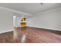An expansive open concept living room with hardwood floors, bright neutral paint, and recessed lighting at 402 Andrea Ln, Hanahan, SC 29410