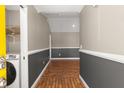 Hallway with stunning herringbone wood floors with washer and dryer at 4788 Porter Dr, North Charleston, SC 29420