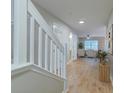 Inviting entryway with wood floors, white trim and neutral walls offers an open view of the living spaces at 546 Tayrn Dr, Charleston, SC 29492