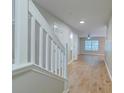 Inviting entryway with wood floors, white trim and neutral walls offers an open view of the living spaces at 546 Tayrn Dr, Charleston, SC 29492