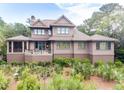 Expansive backyard showcasing a covered porch and meticulously maintained landscaping for outdoor enjoyment at 57 Goldenrod Ct, Kiawah Island, SC 29455