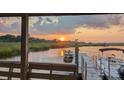 Stunning waterfront view at sunset featuring a dock and boat at 5911 Steward St # 7, Hanahan, SC 29410