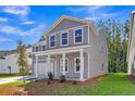 Charming two-story home with gray siding and white trim at 5206 Cottage Lndg Dr, Summerville, SC 29485