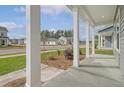 Inviting front porch view showcasing the neighborhood and attractive landscaping at 5213 Cottage Lndg Dr, Summerville, SC 29485