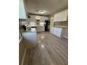 Kitchen boasts updated cabinets, mosaic backsplash, and new laminate flooring at 6983 Vista Ct, North Charleston, SC 29406