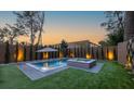 Beautiful backyard with a pool, spa, an umbrella and privacy landscaping at 71 Moultrie St, Charleston, SC 29403