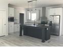 Bright kitchen with stainless steel appliances, an island, and white cabinets for a contemporary aesthetic at 8833 Cottageville Hwy, Cottageville, SC 29435
