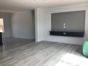 Spacious living room with stylish flooring and a modern entertainment center for a comfortable space at 8833 Cottageville Hwy, Cottageville, SC 29435