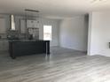 Open-concept living space flowing into a kitchen with an island, perfect for modern living and entertaining at 8833 Cottageville Hwy, Cottageville, SC 29435