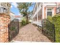 Brick driveway and iron gate leading to a spacious home at 1 Percy St, Charleston, SC 29403