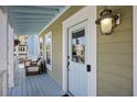 Inviting front porch featuring a charming light fixture and comfortable outdoor seating at 1025 Hunley Waters Cir, North Charleston, SC 29405