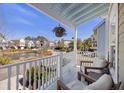 Relaxing outdoor porch seating area with community views at 1025 Hunley Waters Cir, North Charleston, SC 29405