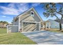 Charming home with a two-car garage, inviting front porch, and well-maintained landscaping at 1028 Island Preserve Rd, Johns Island, SC 29455