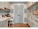 Neatly designed mud room features built-in cabinets, countertop, hanging hooks, and stylish light blue doors at 110 Crosscut Ln, Summerville, SC 29486