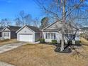 Exterior of home in a suburban neighborhood; the lawn is well-maintained, and a tree in the front provides shade at 111 Pacolet St, Summerville, SC 29485