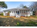Back exterior of the property with a spacious screened in porch and a well-maintained yard at 1217 Bamboo Dr, Charleston, SC 29407