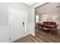 Bright foyer with decorative door, adjacent dining area, and wood flooring at 123 Lakelyn Rd, Moncks Corner, SC 29461