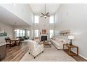 Spacious living room with high ceilings, fireplace, and abundant natural light at 123 Lakelyn Rd, Moncks Corner, SC 29461