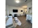 Bright living room with hardwood floors, modern furnishings, and an open concept layout to kitchen at 1252 Allusion Ln # 201, Mount Pleasant, SC 29466