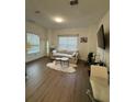 Inviting living room featuring a plush couch, minimalist decor, and a view of the window at 1252 Allusion Ln # 201, Mount Pleasant, SC 29466