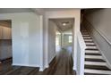 View of the home's entryway with hardwood floors and staircase leading to the second floor at 134 Lilac Grove Way, Summerville, SC 29486