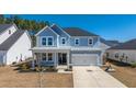 Beautiful two-story home featuring a covered porch, attached garage, and spacious driveway at 143 Oyster Tide Ave, Summerville, SC 29485