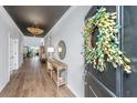 Elegant foyer with wood floors, decorative lighting, and a stylish console table at 143 Oyster Tide Ave, Summerville, SC 29485
