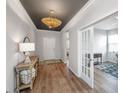 Welcoming foyer with wood-look floors, decorative light fixture and a console table at 143 Oyster Tide Ave, Summerville, SC 29485
