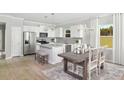 Modern eat-in kitchen with stainless steel appliances and white cabinetry at 148 Royal Cainhoy Way, Huger, SC 29450