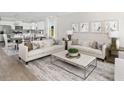 Open concept living room with contemporary decor and eat-in kitchen at 148 Royal Cainhoy Way, Huger, SC 29450