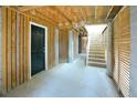 Spacious basement area with concrete floor, paneled walls, and stairwell leading to upper level at 1717 Rivertowne Country Club Dr, Mount Pleasant, SC 29466
