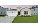 Charming single-Gathering home featuring a well-manicured lawn and an attached two-car garage at 269 Firewheel Ct, Summerville, SC 29486
