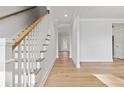 Hallway with hardwood floors and stairway at 3107 S Shore Dr, Charleston, SC 29407